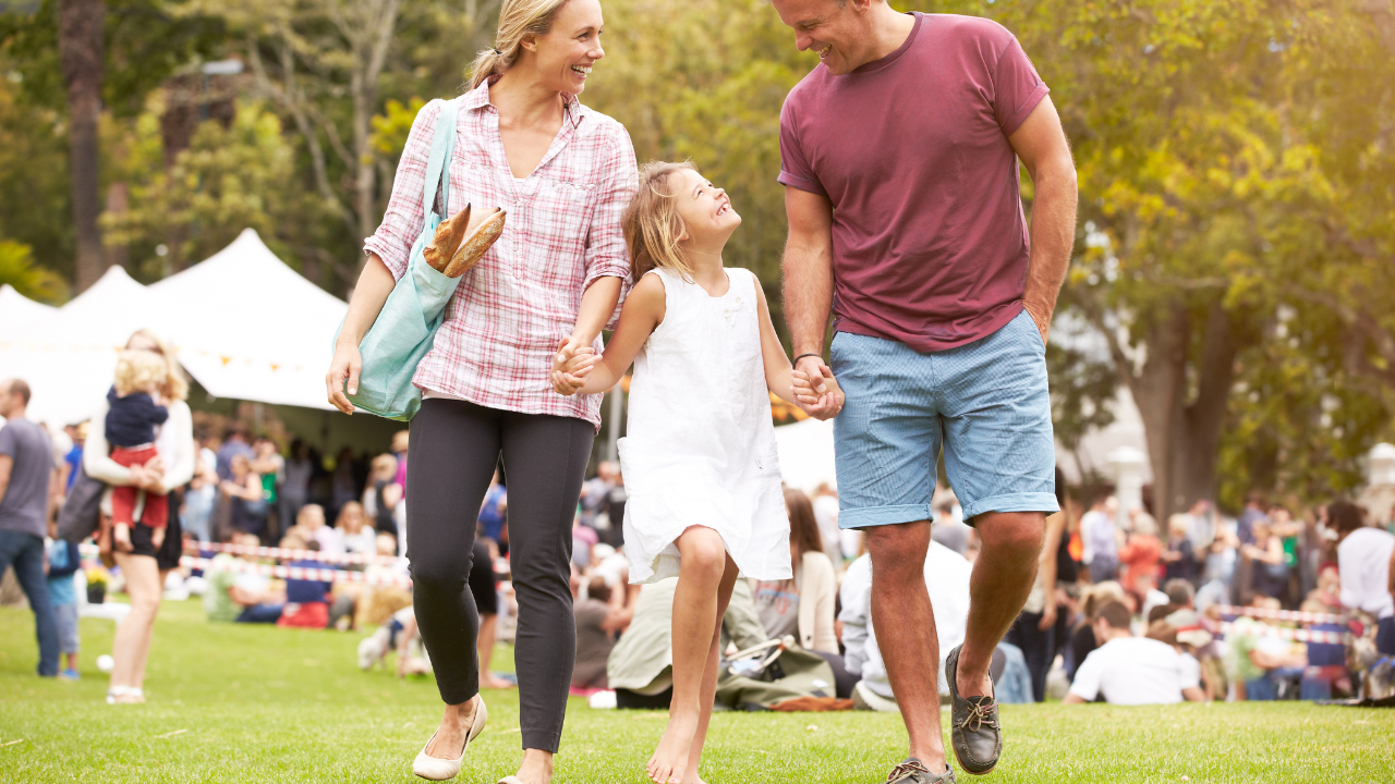 2 adults and a child outdoors
